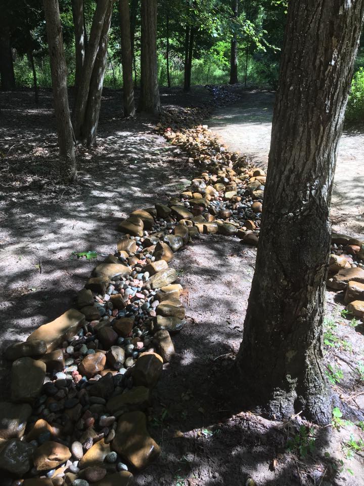 dry creek bed with Arkansas stones for erosion control in West Monroe, La