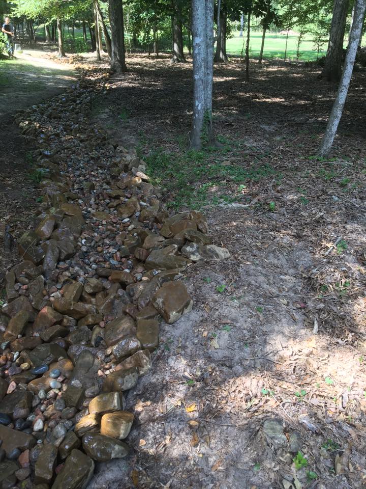 rock work with brown Arkansas creek stones for erosion control in Farmerville, La