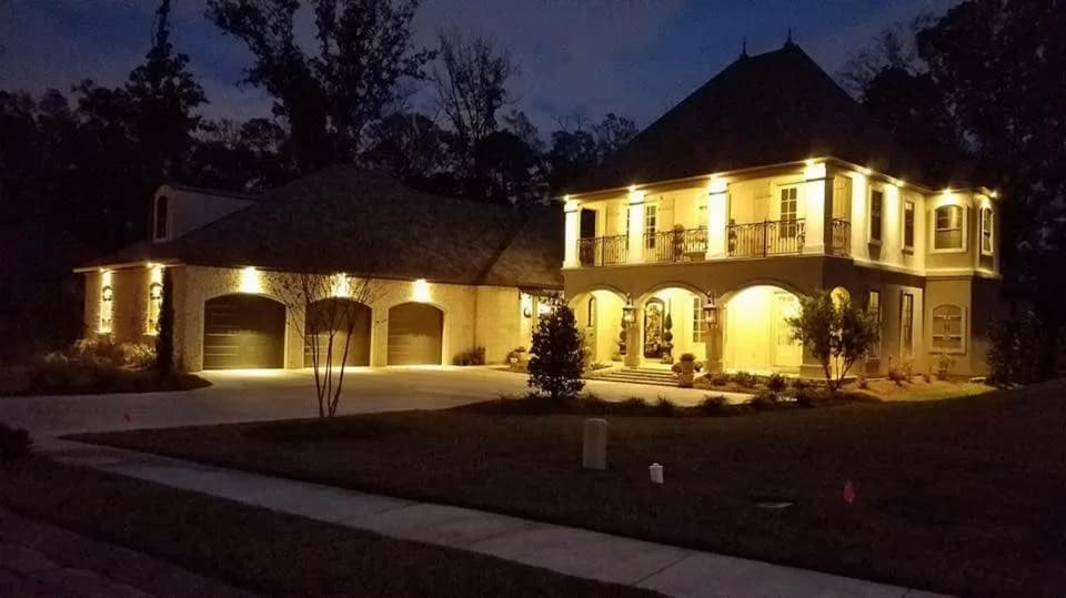 Northeast Louisiana home with custom landscape lighting at night